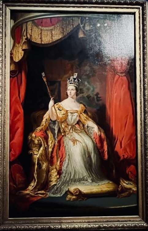 Painting of regal woman with rod and red curtains at the National Portrait Gallery in London